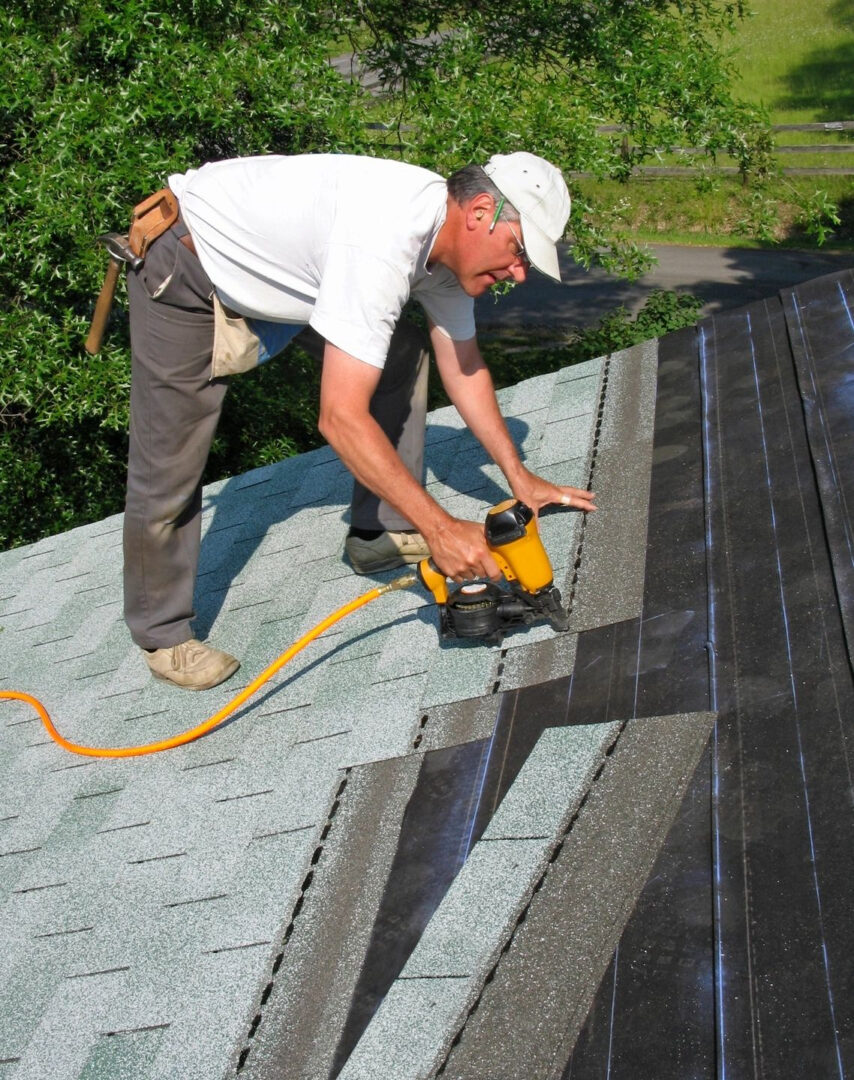 A man working on the roof of his home.